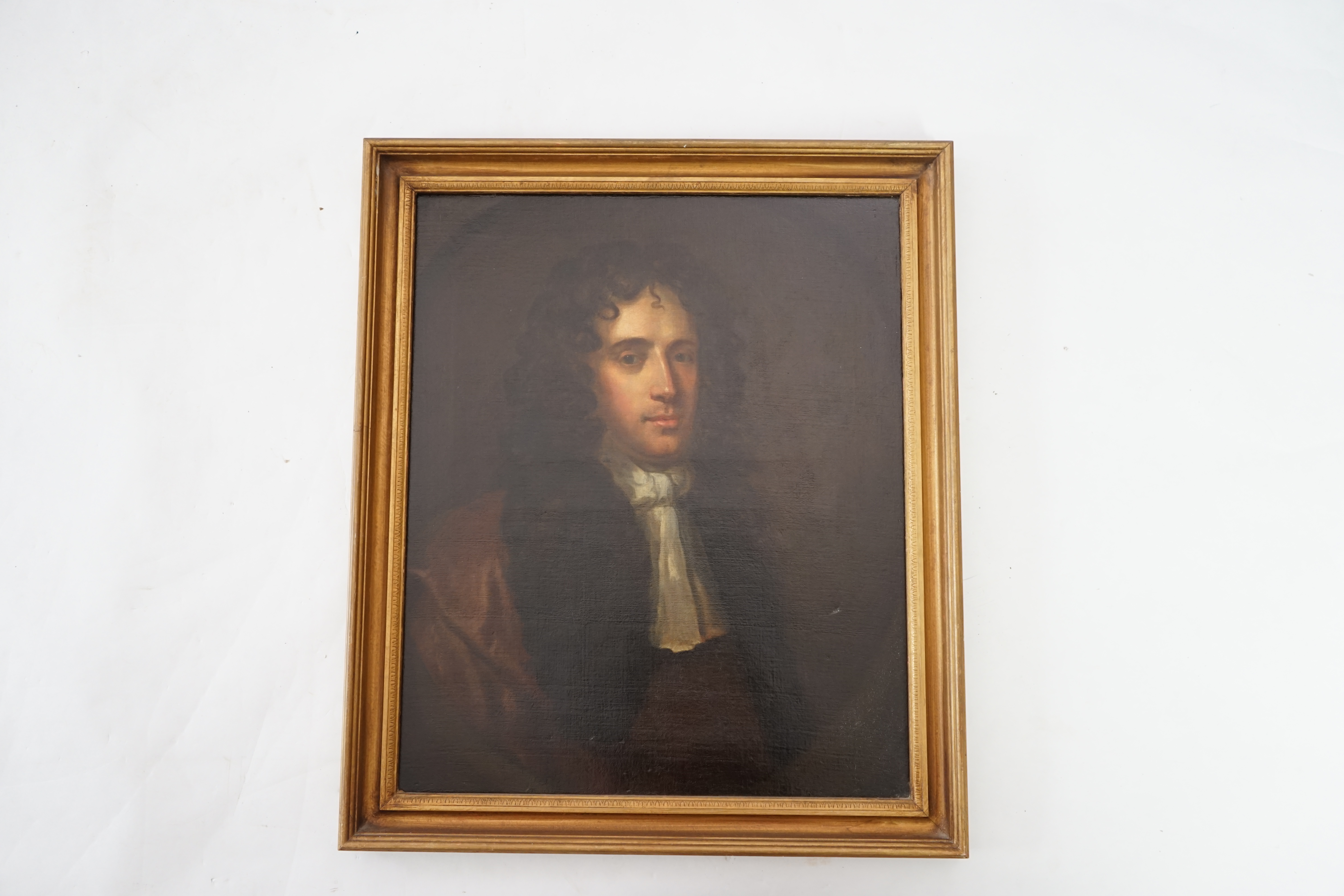 Follower of Sir Peter Lely (1618-1680), Half length portrait of a gentleman in a brown coat and white stock, oil on canvas